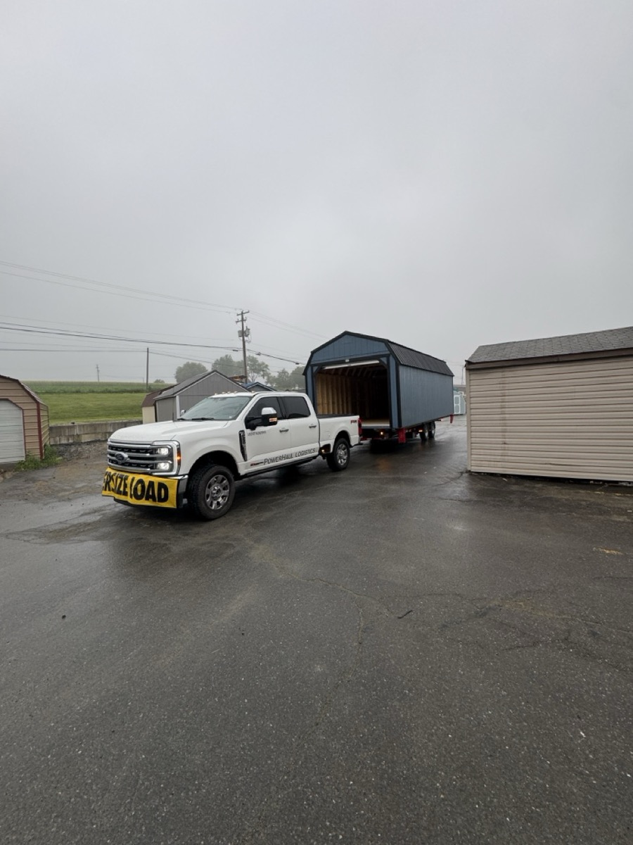 Powerhaul Logistics truck hauling a shed